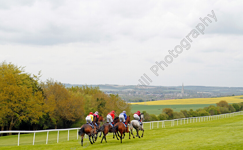 Pretty-Jewel-0007 
 PRETTY JEWEL (blue, Luke Catton) tracks the leaders on her way to winning The Peter Symonds Catering Fillies Handicap Salisbury 30 Apr 2018 - Pic Steven Cargill / Racingfotos.com