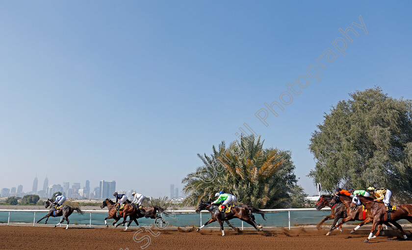 Jebel-Ali-0010 
 Horses take the home turn at Jebel Ali in the second race won by GAVROCHE (green) Dubai 9 Feb 2018 - Pic Steven Cargill / Racingfotos.com