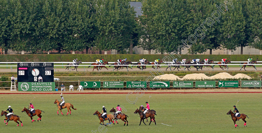 Deauville-0013 
 Horses race along the back straight past a polo match on the field
Deauville 8 Aug 2020 - Pic Steven Cargill / Racingfotos.com