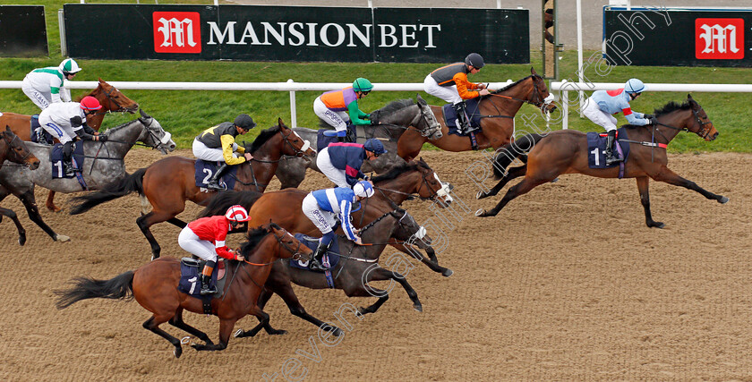 Notre-Belle-Bete-0002 
 NOTRE BELLE BETE (blue and white, David Probert) with the field led by MYKONOS ST JOHN (right) on his way to winning The Mansionbet Lincoln Trial Handicap
Wolverhampton 12 Mar 2022 - Pic Steven Cargill / Racingfotos.com