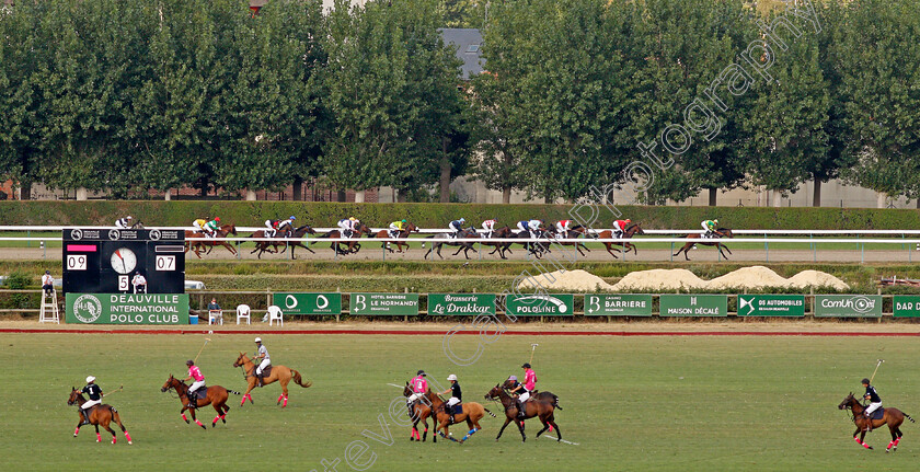 Deauville-0012 
 Horses race along the back straight past a polo match on the field
Deauville 8 Aug 2020 - Pic Steven Cargill / Racingfotos.com