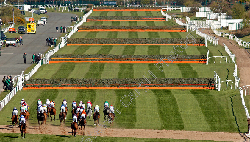 Livelovelaugh-0003 
 The field approaches the 4th fence in the Randox Topham Handicap Chase won by LIVELOVELAUGH
Aintree 9 Apr 2021 - Pic Steven Cargill / Racingfotos.com