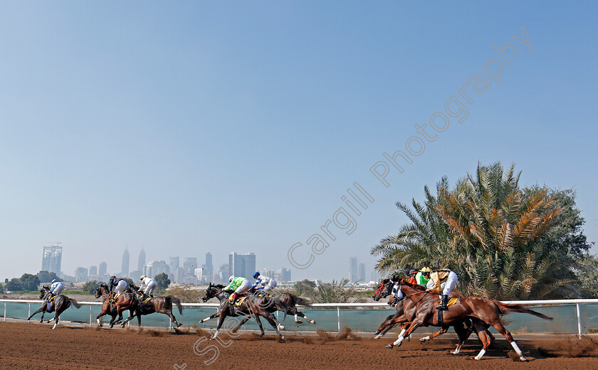 Jebel-Ali-0011 
 Horses take the home turn at Jebel Ali in the second race won by GAVROCHE (green) Dubai 9 Feb 2018 - Pic Steven Cargill / Racingfotos.com