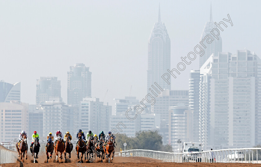 Jebel-Ali-0006 
 Horses race down the back straight at Jebel Ali in the first race won by HAWKER (left) Dubai 9 Feb 2018 - Pic Steven Cargill / Racingfotos.com