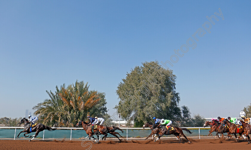 Jebel-Ali-0008 
 Horses take the home turn at Jebel Ali in the second race won by GAVROCHE (green) Dubai 9 Feb 2018 - Pic Steven Cargill / Racingfotos.com