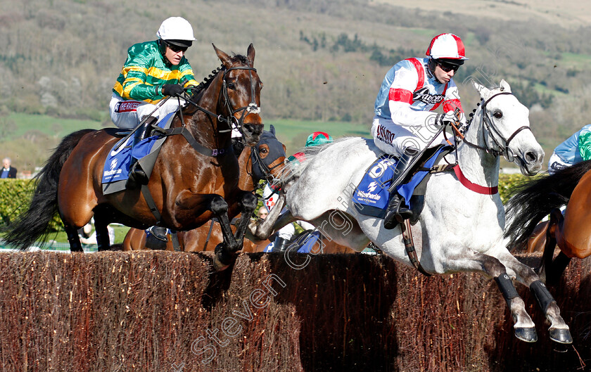 Another-Hero-0001 
 ANOTHER HERO (left, Barry Geraghty) jumps with VIC DE TOUZAINE (right) on his way to winning The Weatherite Handicap Chase Cheltenham 18 Apr 2018 - Pic Steven Cargill / Racingfotos.com