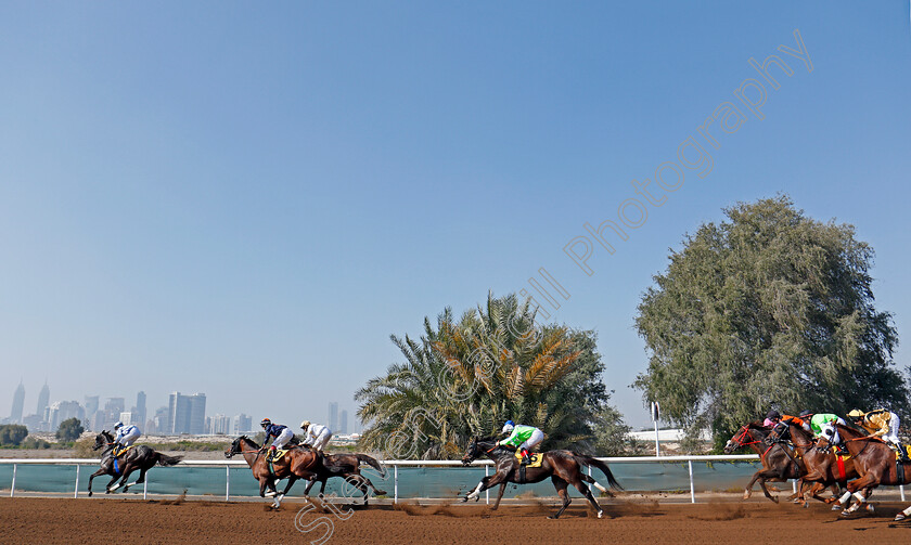 Jebel-Ali-0009 
 Horses take the home turn at Jebel Ali in the second race won by GAVROCHE (green) Dubai 9 Feb 2018 - Pic Steven Cargill / Racingfotos.com