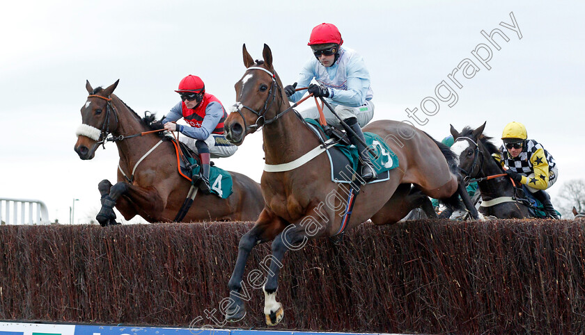 Barbados-Blue-and-Clondaw-Caitlin 
 BARBADOS BLUE (centre, Nico de Boinville) with CLONDAW CAITLIN (left)
Warwick 9 Dec 2021 - Pic Steven Cargill / Racingfotos.com